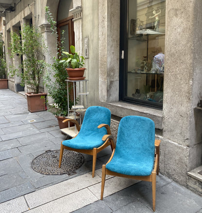 Two turquoise chairs outside an antiquarian bookshop in Trieste's Jewish quarter