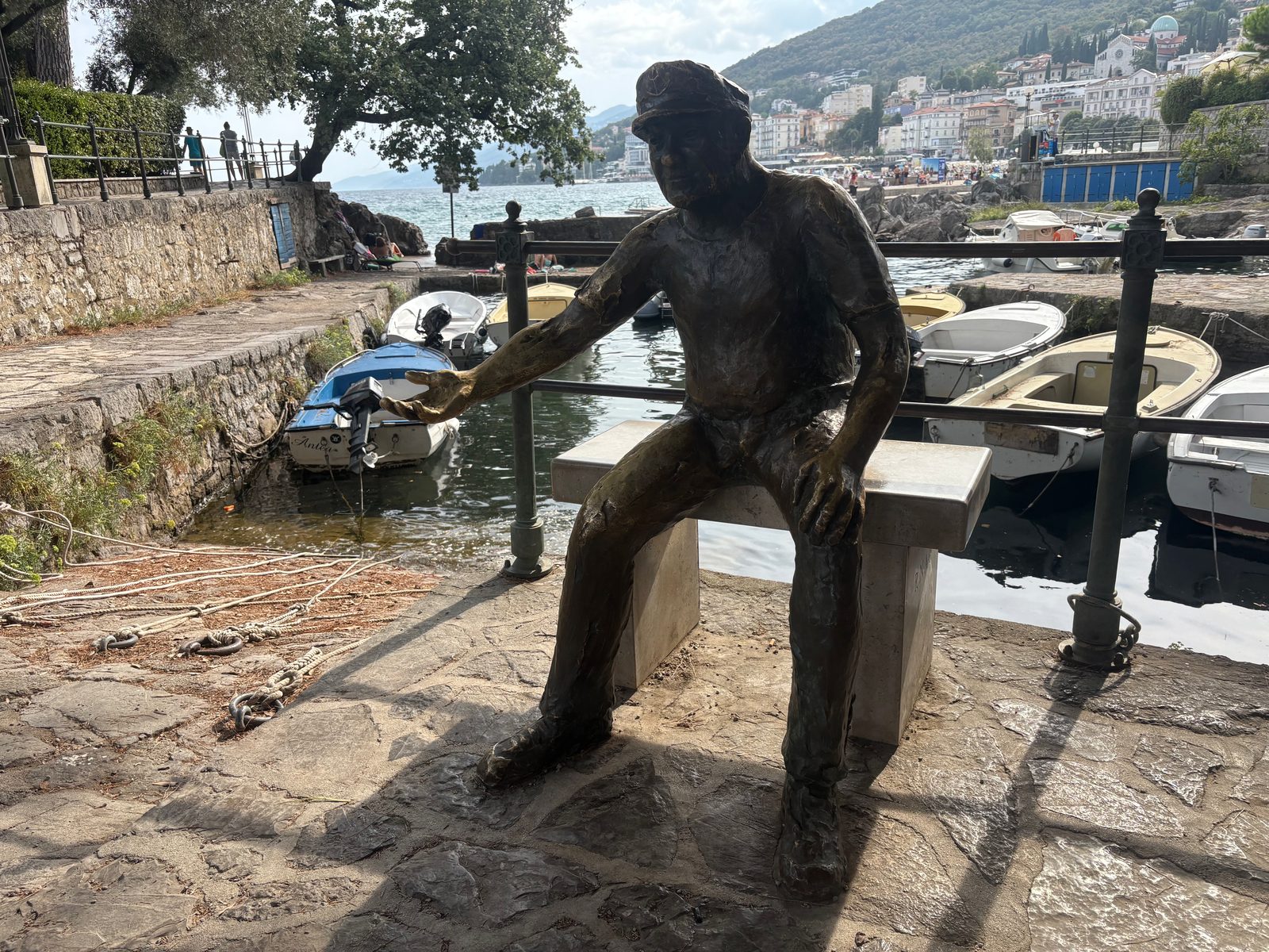 Die Bronzefigur des Barkajol, des Bootsmanns von Opatija, auf der Mole des kleinen Hafens Portić.
