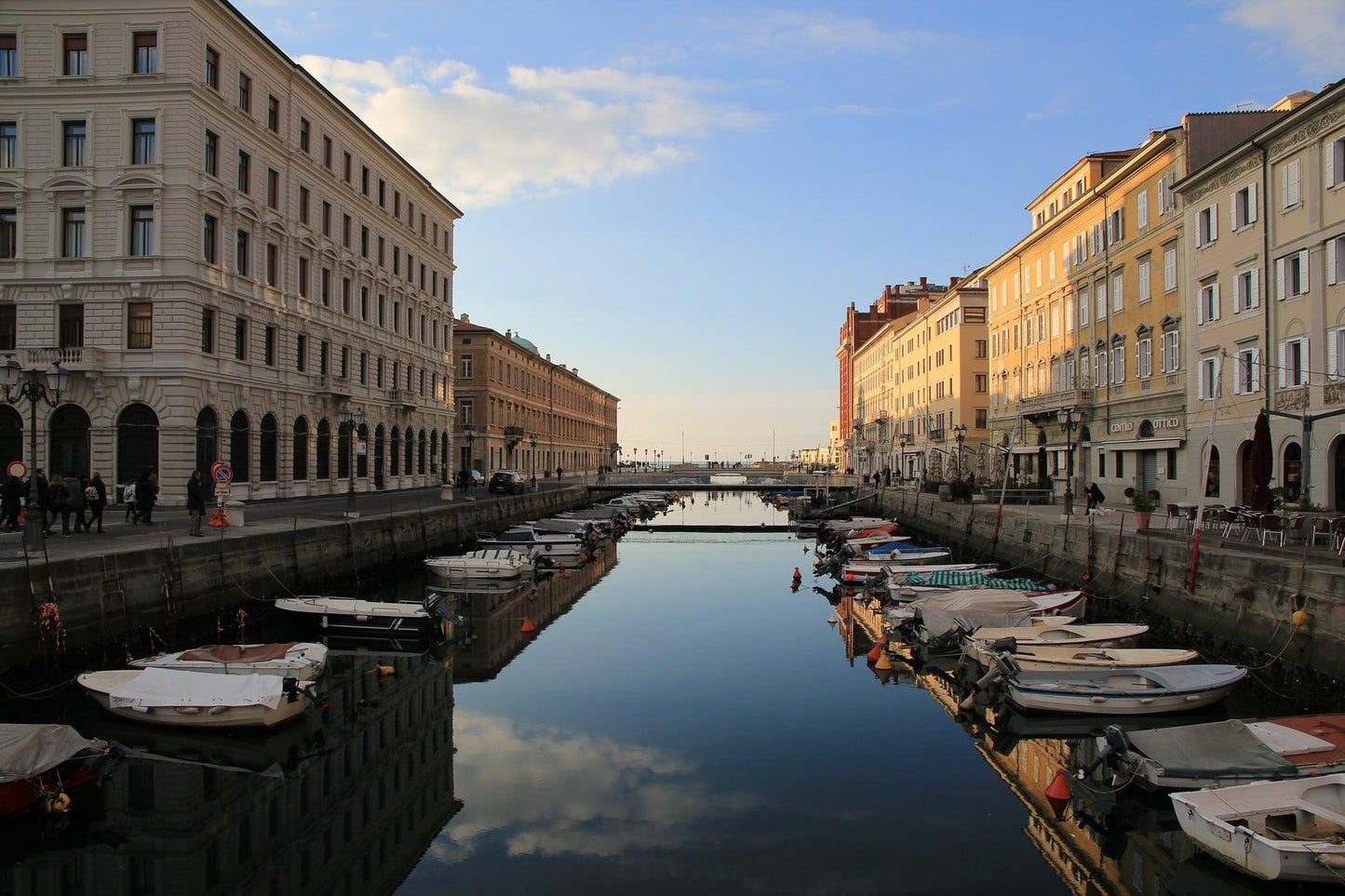 Trieste's Canal Grande with boats and reflections in the evening sun