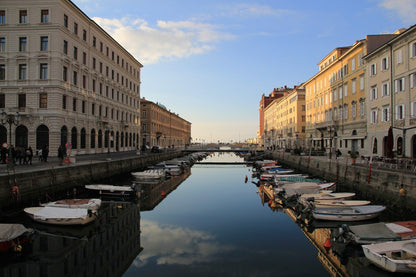 Trieste's Canal Grande with boats and reflections in the evening sun