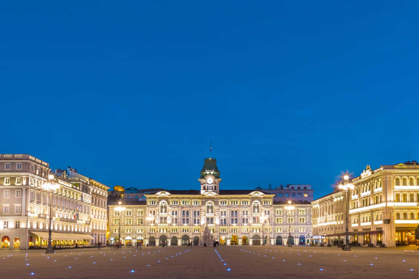 Piazza Unità d'Italia in Trieste at blue hour with the illuminated town hall
