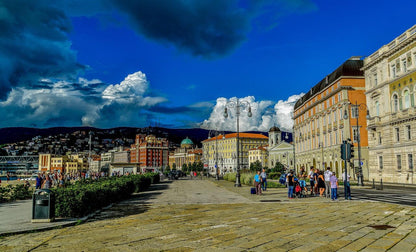 Trieste's Rive waterfront promenade under a dramatic sky over the Adriatic