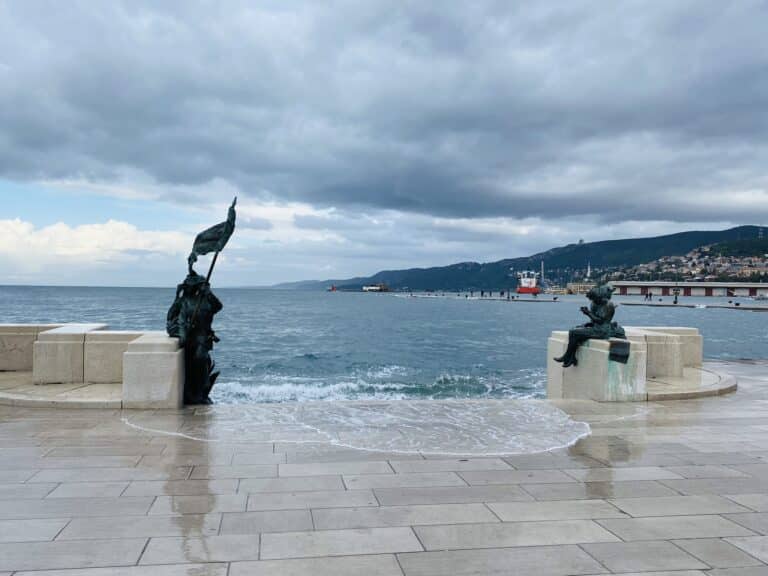 Scala Reale in Trieste during acqua alta, with the sea washing over the steps
