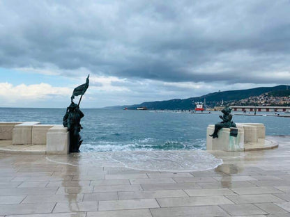 Scala Reale in Trieste during acqua alta, with the sea washing over the steps